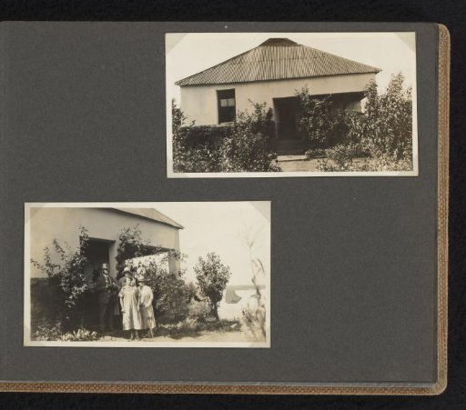 Two women and a man at a dwelling, probably in South Africa