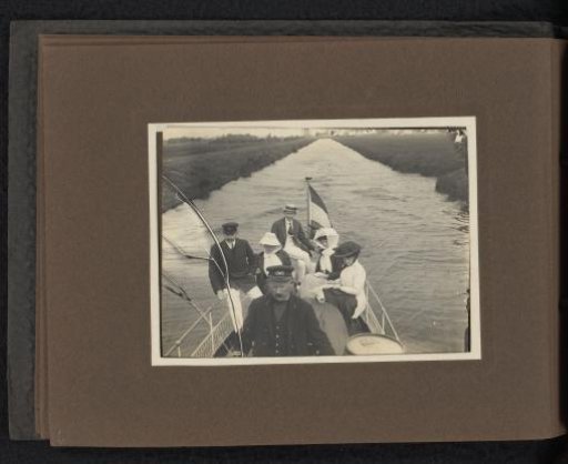 Company on a motorboat in a canal