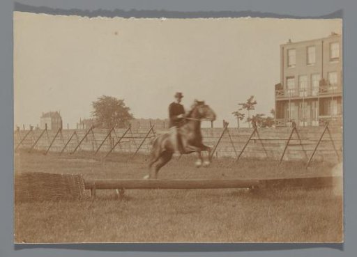 A Man Riding the Photographer's Horse Bobbie Taking an Obstacle on the Terrain behind the Rijksmuseum