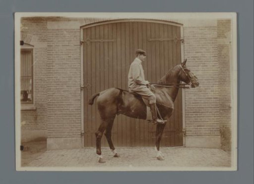 Henk van de Berg on his horse Bobbie in front of the shed