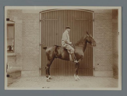 Henk van de Berg on his horse Bobbie in front of the barn