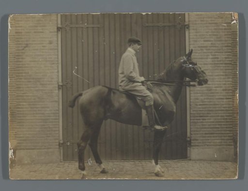 Henk van de Berg on his horse Bobbie in front of the shed