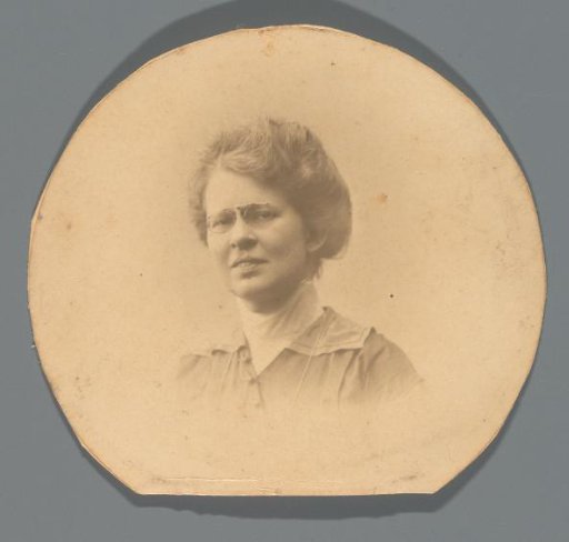 Portrait of a woman with glasses and hair pinned up