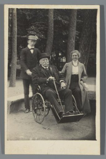 Norbert van den Berg in a wheelchair with a man and woman behind and beside him