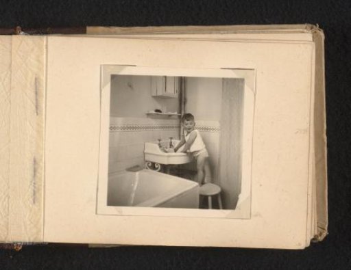 Norbert Peter van den Berg as a toddler by a washbasin in a bathroom, facing the camera