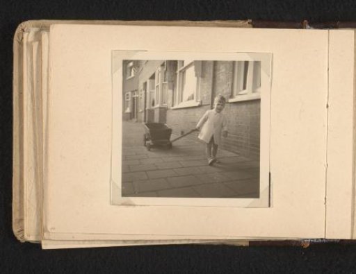 Norbert Peter van den Berg as a toddler on the street with a tricycle