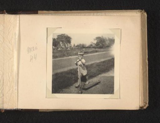 Norbert Peter van den Berg as a toddler with a scooter outdoors