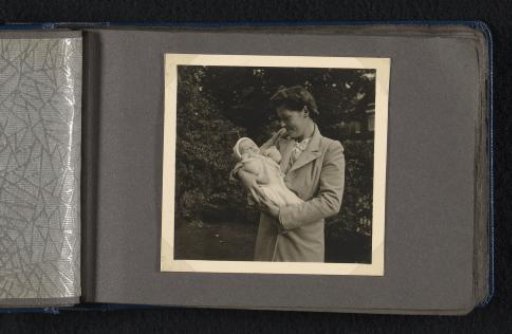 Maria Louise van den Berg-Halbertsma holding her newborn son Norbert in her arms in a garden