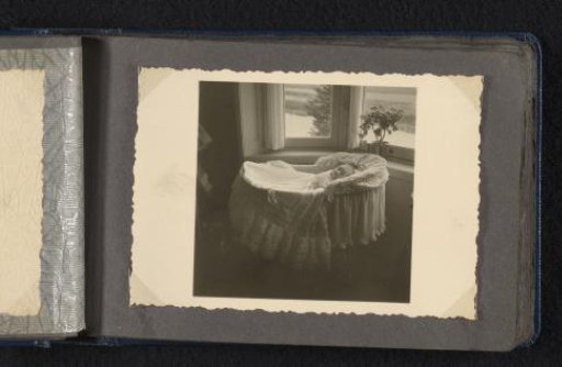 Norbert Peter van den Berg as a Newborn Baby in a Baptismal Gown in a Cradle