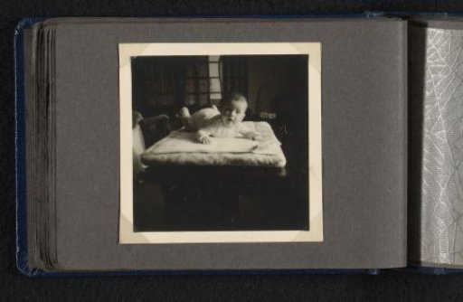 Norbert Peter van den Berg as a newborn baby, lying on his stomach on a rug, seen from the front