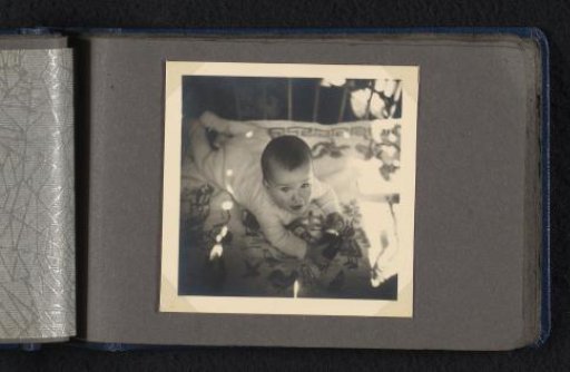 Norbert Peter van den Berg as a baby, seen from above, lying on his stomach on a rug