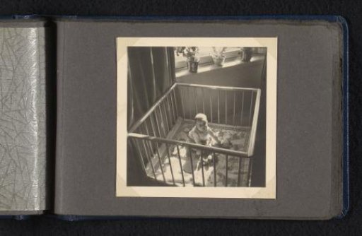 Laughing Norbert Peter van den Berg as a baby, sitting in a crib