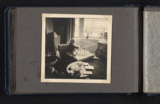 Caroline Louise van den Berg seated by a box with her newborn grandson Norbert