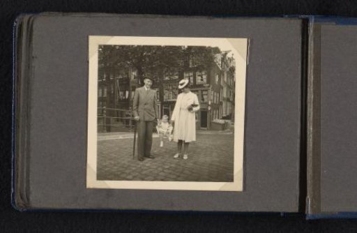 Frank Willem van den Berg and Maria Louise van den Berg-Halbertsma Carry Their Son Norbert in a Sling on the Street