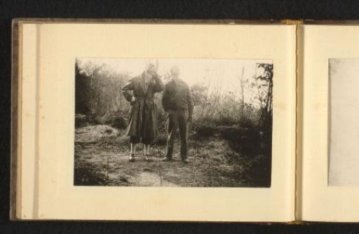 Two men in a forest, looking upwards