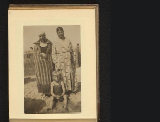 Woman, man, and boy in bathing attire on the beach