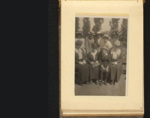 Group portrait with eight persons in a garden