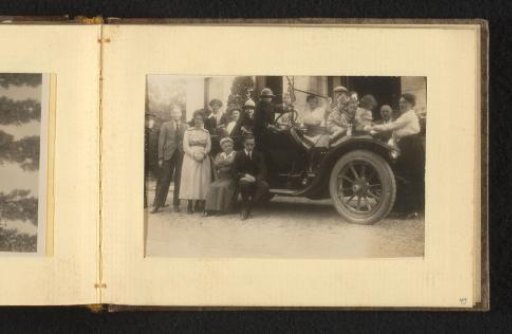 Group portrait with 19 people in and around a car