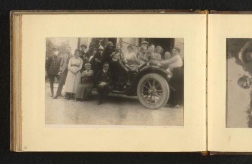 Group portrait with 19 people in and around a car
