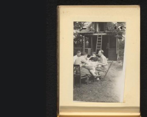 Three Men and a Woman at a Table Outdoors