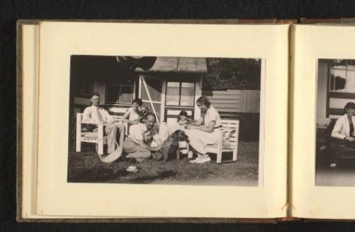 People on a terrace in a garden with a dog