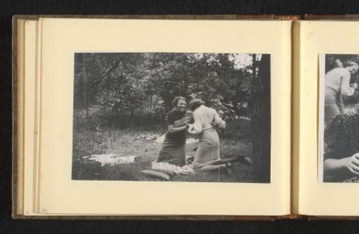Two women wrestling in the grass