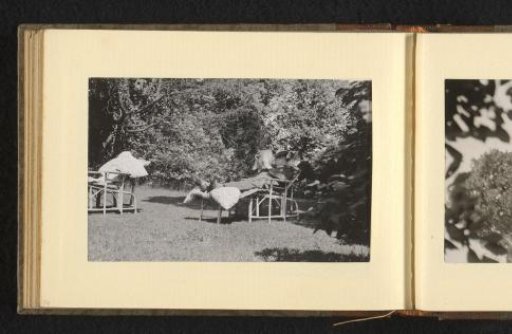 Reading man on a chair with a footstool in a garden