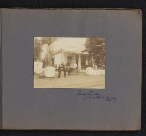 Two men in a horse-drawn carriage, with a servant nearby, in Batavia