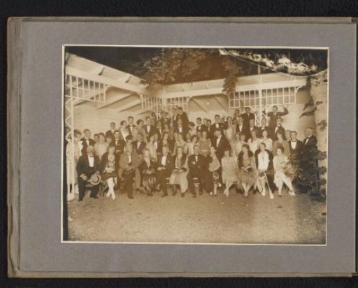 Group portrait of a company in evening dress