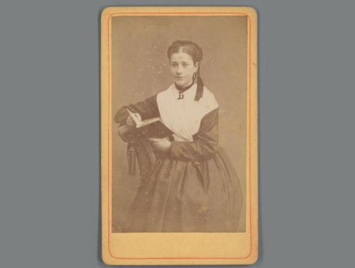Portrait of an unknown young woman with a book from the family and circle of Eugene van Delden and Belle van Delden-Denninghof Stelling