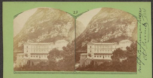 Large building at the foot of the Alps