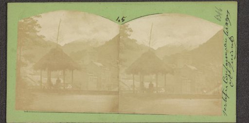 Pavilion with thatched roof with the Alps in the background