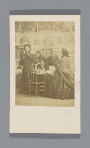 Group with stereographs at a table and prints on the wall