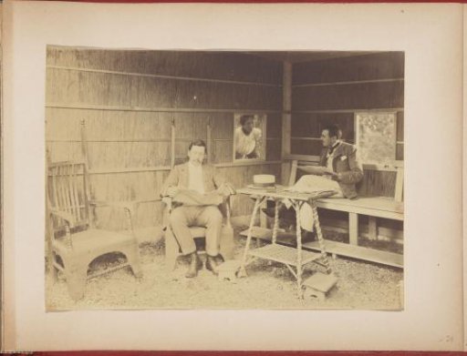 Gerard Aalbersberg and Jan Kleintjes reading under a veranda, Hedwig Kleintjes looking through the window