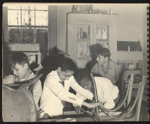 Four boys repairing chairs