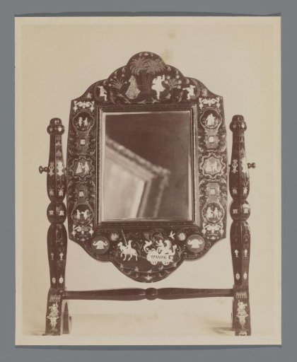 View of a mirror, with a painting frame reflected in it