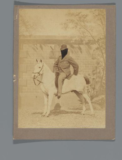 Man on horseback with face retouched out