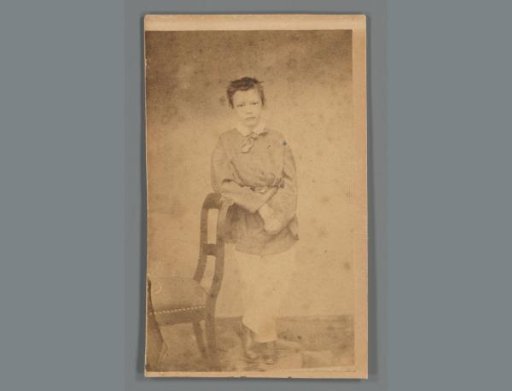 Portrait of Dirk van Haren Noman as a child leaning against a chair