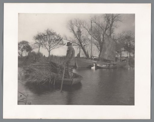 Man in a rowing boat with twigs