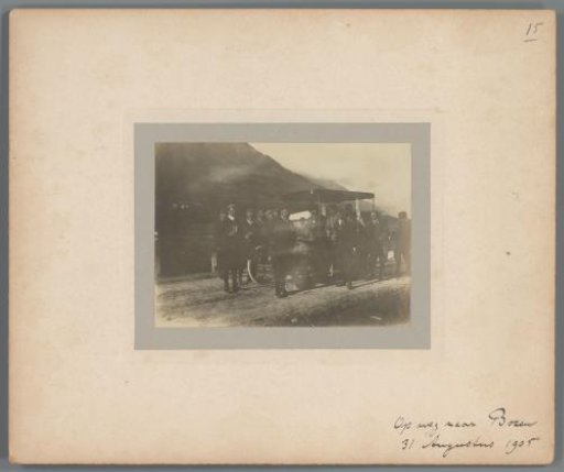 Group portrait of unknown men with glasses of beer around a car, near Bolzano