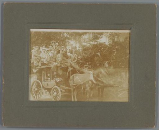 Group portrait of a group of unknown people on a carriage
