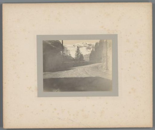 Two men sitting by a mountain road in the Alps