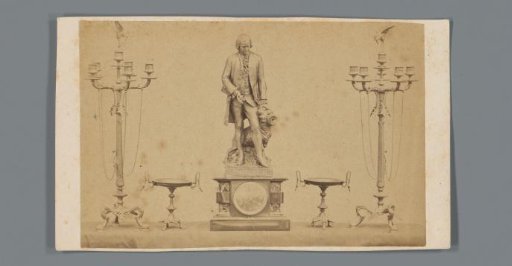 Two candelabra, two bowls and a clock with bronze statue, advertisement for founder Delesalle & Cie