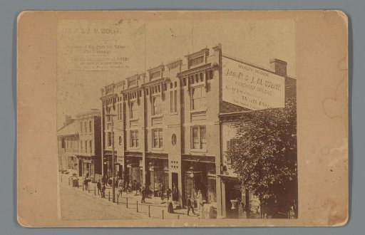 Advertisement featuring a view of Wolff Block, the premises of textile merchants Jas. P. & J.M. Wolff in Waynesboro, Pennsylvania