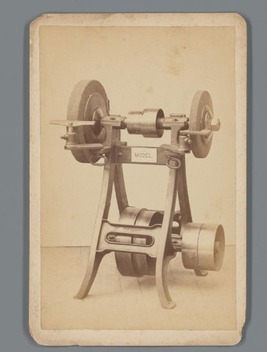 Advertisement with a grinding machine with two grindstones