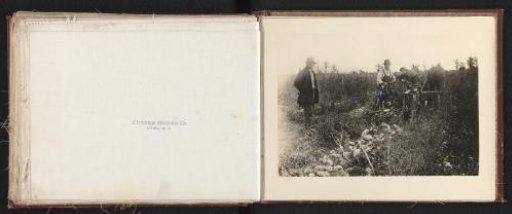 Farmers on the land with an agricultural implement of the Eureka Mower Co. in Utica
