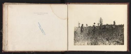 Farmers on the land with an agricultural implement of the Eureka Mower Co. in Utica