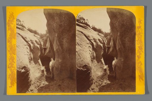 View of a cave with a horse under the Kaiparowits Plateau, Utah