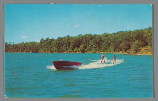 Speedboat with jet skis on a lake (Benedict, Minnesota)