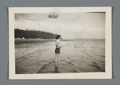 Woman standing at the edge of a lake